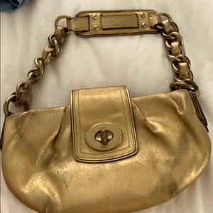 Well-worn gold coach bag